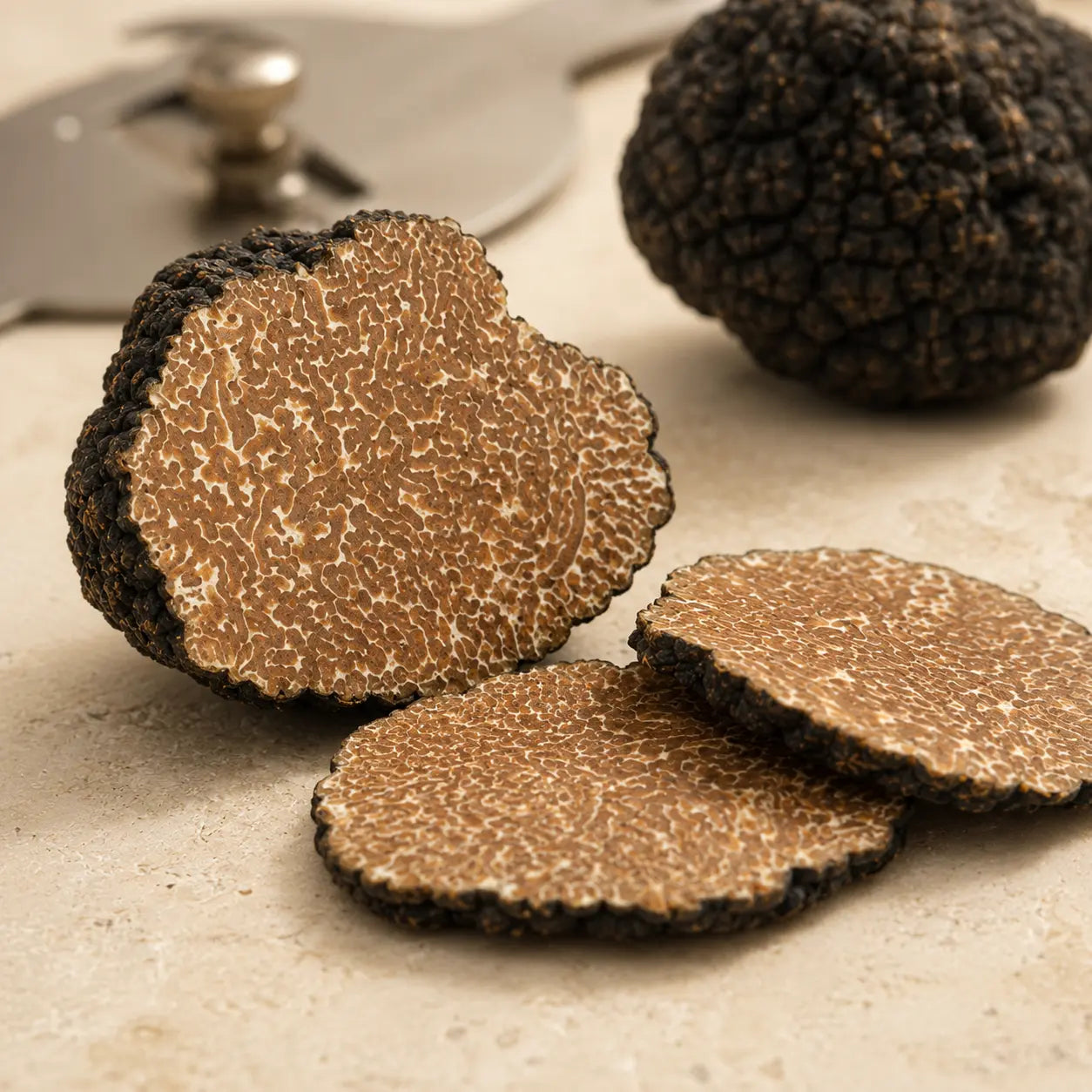 Cut Black Autumn Truffle Tuber uncinatum showing marbled interior and autumn truffle texture